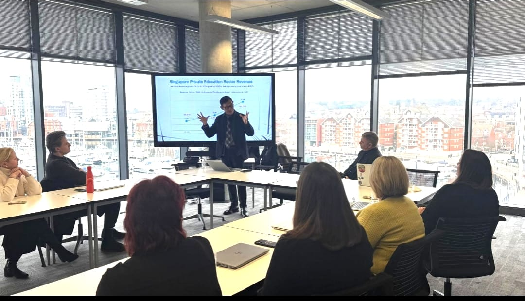 Dr. Alan Go — addressing University of Suffolk executives, UK